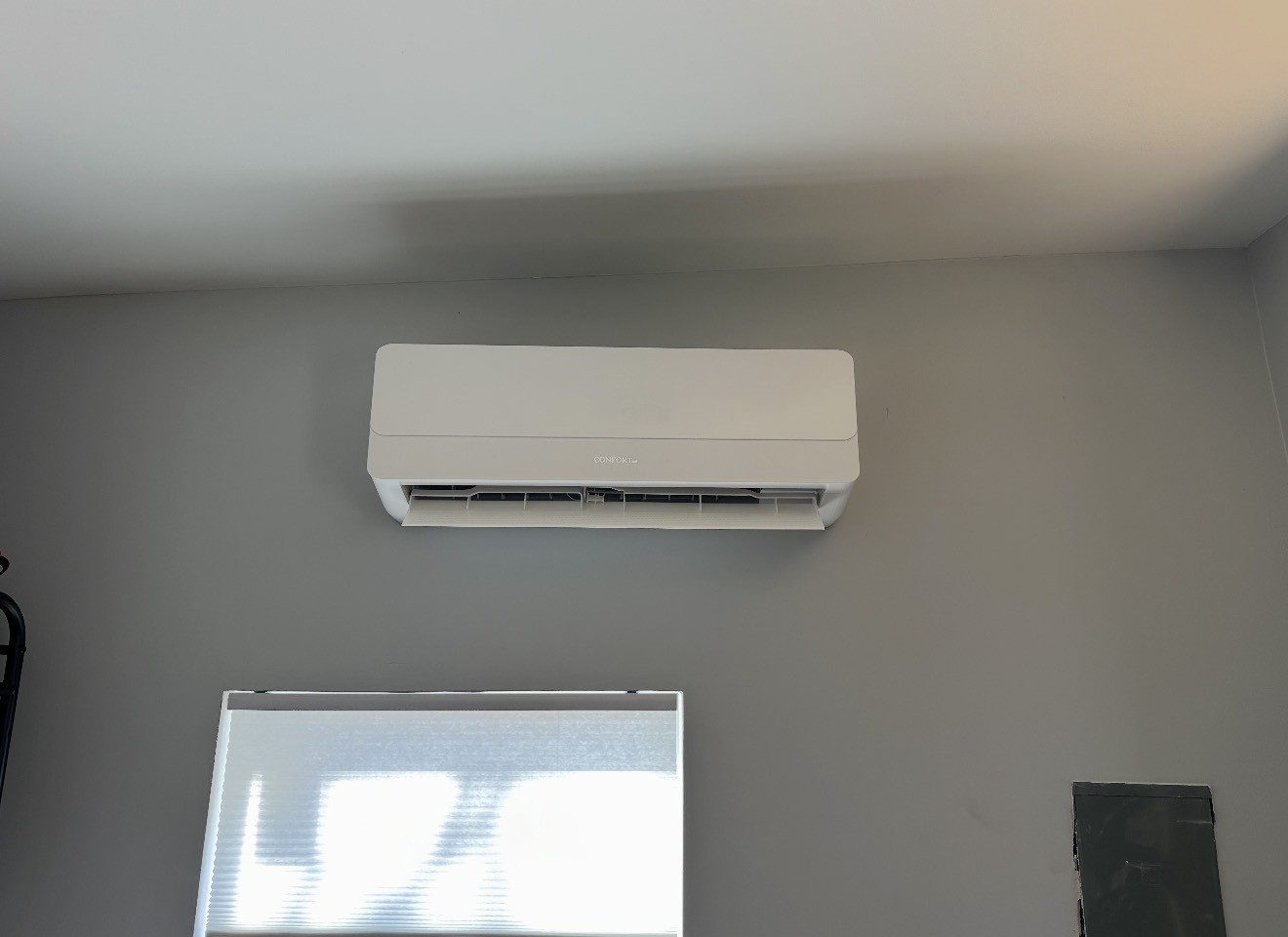 Indoor ductless mini-split mounted above a window