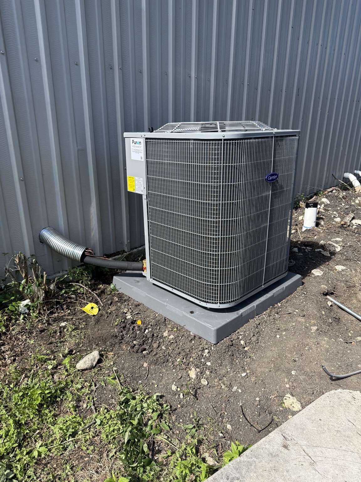 After installation: Carrier condenser installed on an equipment pad